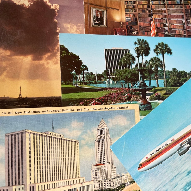 May include: A vintage postcard featuring a view of the Los Angeles City Hall, the New Post Office and Federal Building, and a fountain in a park. The postcard is titled "LA. 26 - New Post Office and Federal Building - and City Hall, Los Angeles, California."