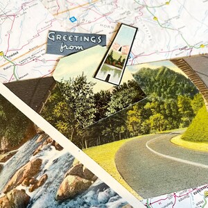 May include: A vintage postcard featuring a scenic road winding through a lush green forest. The postcard has a blue border and the text "Greetings from" printed on it.