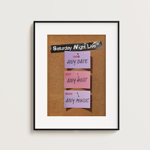 May include: Framed corkboard with three colorful sticky notes. The top note reads "ANY DATE" under "SHOW". The middle note says "ANY HOST" under "HOST". The bottom note says "ANY MUSIC" under "MUSIC". The text "Saturday Night Live UK" is above the notes.