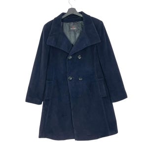 May include: A navy blue double-breasted coat with a wide collar and two rows of buttons. The coat has a tailored fit and a classic design, suitable for cooler weather. The coat is hanging on a black hanger.