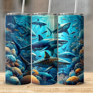 May include: A set of three stainless steel tumblers with a colorful underwater scene featuring sharks, coral reefs, and tropical fish. The tumblers are perfect for keeping drinks cold or hot.
