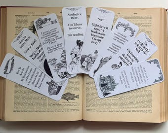 May include: A collection of white rectangular bookmarks with black text and vintage-style illustrations. Each bookmark features unique quotes and decorative borders, fanned out across the open pages of a vintage dictionary with visible text.