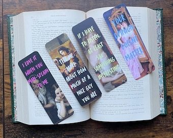 May include: Set of four bookmarks featuring vintage paintings with humorous text overlays. The bookmarks feature a woman in a pink dress, a woman in a blue dress, a woman in a red dress, and a woman in a white dress. The text on the bookmarks reads: "I love it when you man-splain to me", "Tell me more about how much of a nice guy you are", "If I have to listen, at least say something interesting", and "Your opinion doesn't matter".