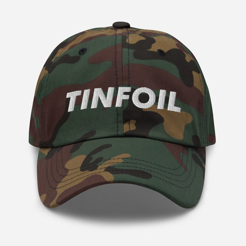 May include: A camouflage baseball cap with the word "TINFOIL" embroidered in white on the front.