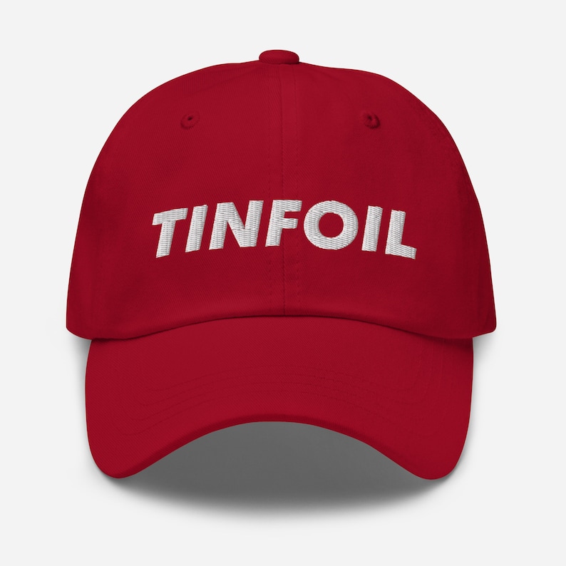 May include: A red baseball cap with the word "TINFOIL" embroidered in white on the front.