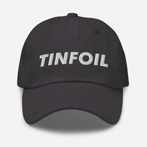 May include: A dark grey baseball cap with the word "TINFOIL" embroidered in white on the front.