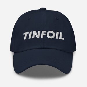 May include: A navy blue baseball cap with the word "TINFOIL" embroidered in white on the front.