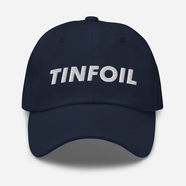 May include: A navy blue baseball cap with the word "TINFOIL" embroidered in white on the front.
