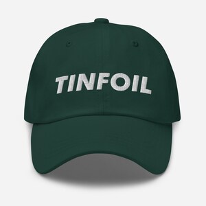 May include: A dark green baseball cap with the word "TINFOIL" embroidered in white on the front.