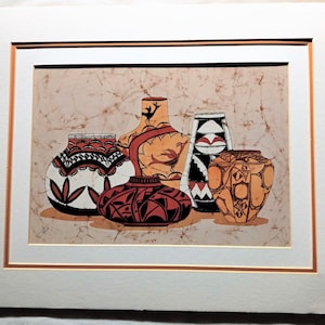 May include: A framed print of five ceramic pots with geometric patterns in shades of red, orange, black, and white on a beige background.