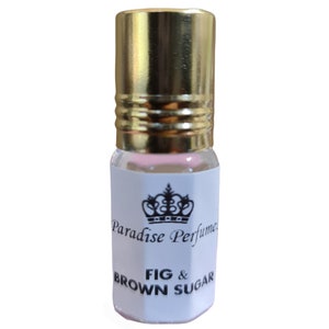 May include: A small glass bottle with a gold cap and a white label. The label features a black crown and the text "Paradise Perfumes" and "FIG & BROWN SUGAR".
