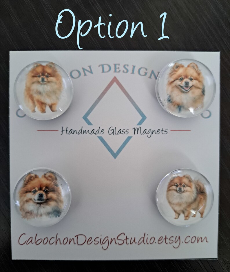 May include: Set of four round glass magnets featuring a watercolor painting of a Pomeranian dog. The magnets are white with a clear glass dome and are arranged in a square shape on a white background. The text "Handmade Glass Magnets" is printed in black below the magnets. The text "CabochonDesignStudio.etsy.com" is printed in brown at the bottom of the image.