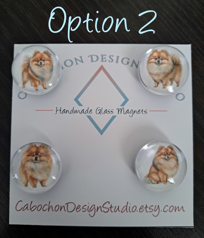 May include: Set of four round glass magnets featuring a watercolor illustration of a Pomeranian dog. The magnets are white with a clear glass dome and are displayed on a white card with the text "CabochonDesignStudio.etsy.com" and "Handmade Glass Magnets".