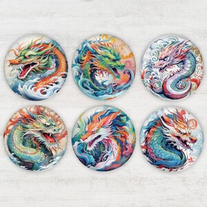 May include: Six round decorative magnets featuring colorful dragon illustrations. Each magnet showcases a different dragon design with vibrant hues of red, green, blue, and orange. The dragons are depicted in a dynamic, artistic style.