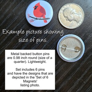 May include: A set of six 0.98 inch round metal backed button pins featuring a cardinal bird on a branch with red berries. The pins are the same size as a US quarter.