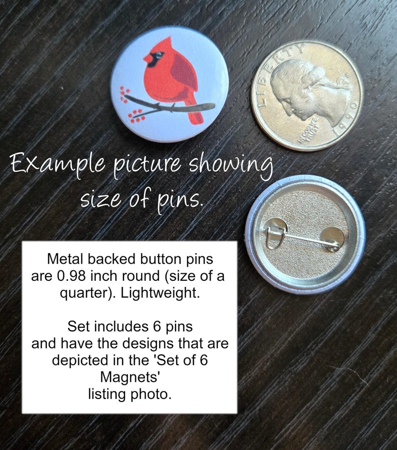 May include: A set of six 0.98 inch round metal backed button pins featuring a cardinal bird on a branch with red berries. The pins are the same size as a US quarter.