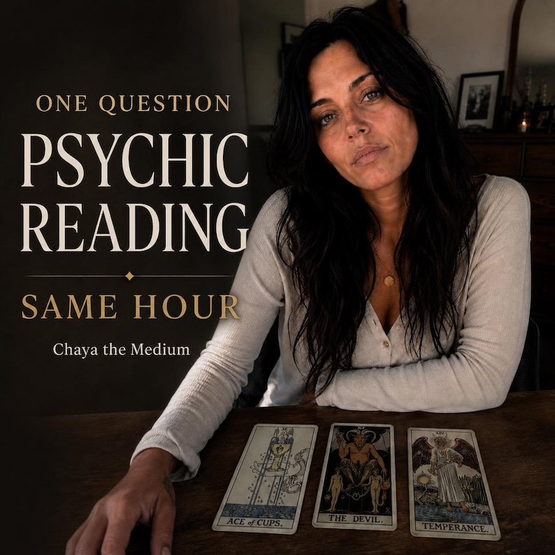 May include: A person with long dark hair wearing a cream-colored long-sleeve shirt sits behind a wooden table with three tarot cards: Ace of Cups, The Devil, and Temperance. Text reads: ONE QUESTION PSYCHIC READING SAME HOUR Chaya the Medium.
