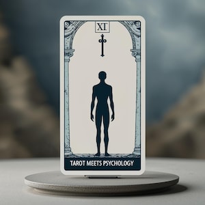 May include: A tarot card featuring a silhouetted human figure standing between two columns, with a cross at the top. The card is labeled "XI" and the text "TAROT MEETS PSYCHOLOGY" is at the bottom. The card is on a round, gray pedestal.