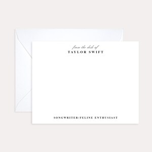 May include: White stationery with black text. The text reads "from the desk of TAYLOR SWIFT SONGWRITER/FELINE ENTHUSIAST"