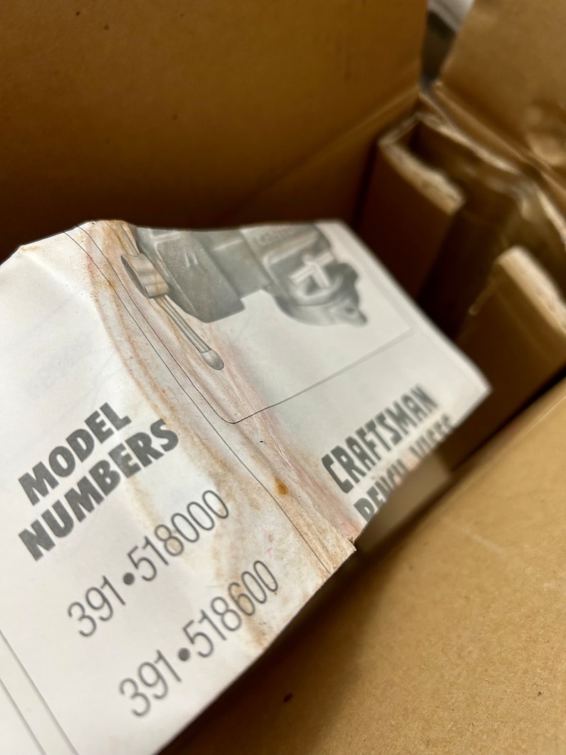 May include: Close-up of a white label with the text "MODEL NUMBERS 391-518000 391-518600" and the text "CRAFTSMAN BENCH VICE" partially visible.
