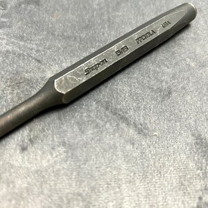 May include: A black metal punch with the text "Snap-on 5/8" and "PROTO USA" engraved on the side.