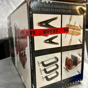 May include: A box of Sears Craftsman clamps, including spring clamps, C-clamps, and adjustable gluing clamps. The box is red, white, and black with the Sears logo.