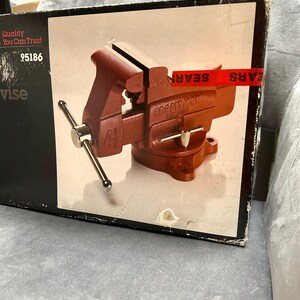 May include: A red Craftsman 4 1/2 inch vise in a black box with the Sears logo. The box also says "Quality You Can Trust" and "95186".