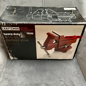 May include: A red Craftsman heavy-duty 4 1/2-inch swivel vise with a black handle. The vise is on a black box with the text "Craftsman Quality You Can Trust 95186" and "heavy-duty 4 1/2-in. swivel vise" printed on it.