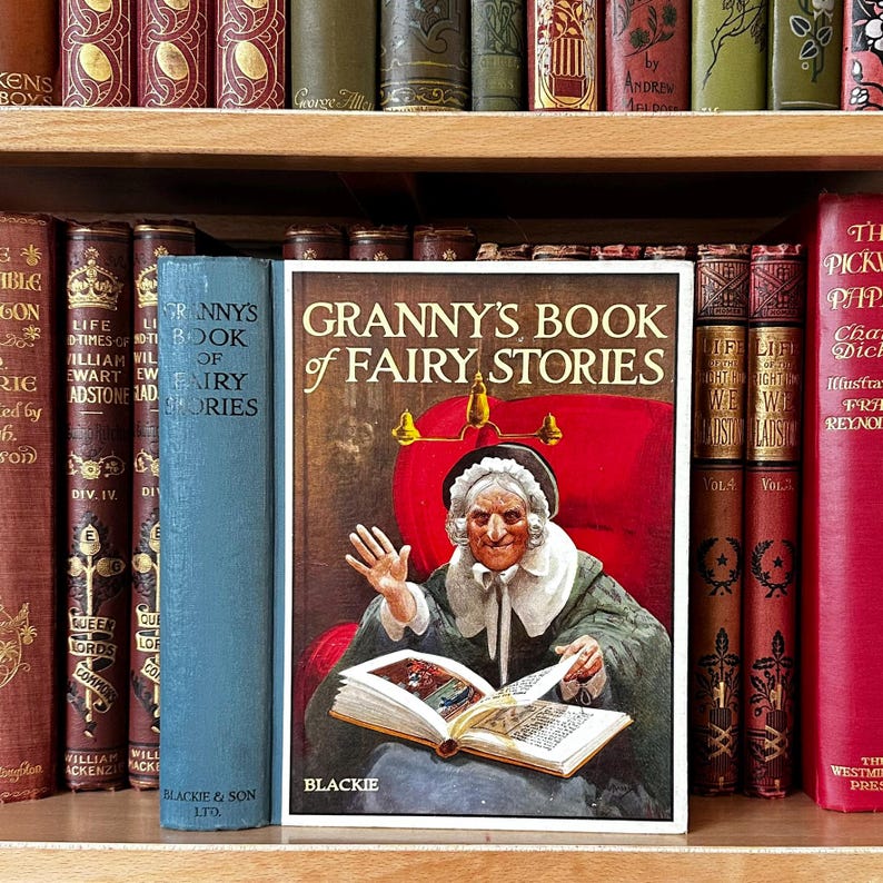 May include: A white ceramic mug with a black handle and the text "But First, Coffee" in a black, handwritten-style font. The mug is on a white surface.