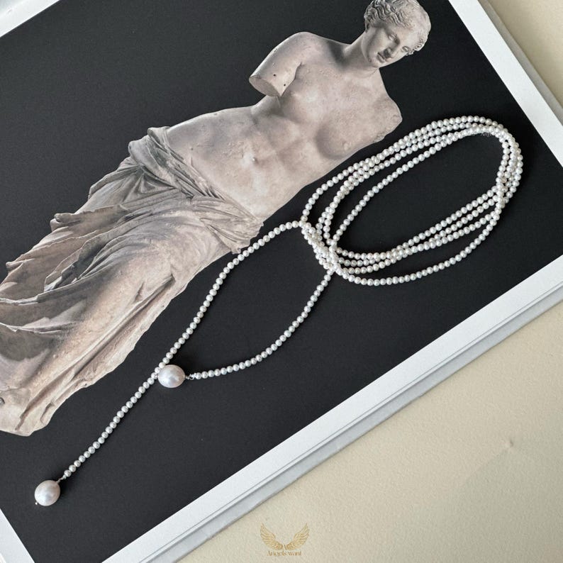 This freshwater pearl necklace is all about elegance and versatility. Featuring 2-3mm petitie pearls with two 10mm drop pearls, it can be wrapped, knotted, or worn long depending on your mood.