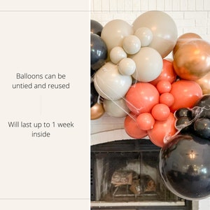 May include: A balloon arch in shades of black, gold, peach, and cream, arranged in a semi-circle. The balloons are of varying sizes and textures. Text on the left states, "Balloons can be untied and reused" and "Will last up to 1 week inside."