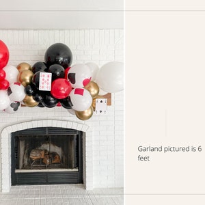 May include: A red, black, gold, and white balloon garland with playing card cutouts, measuring 6 feet long, is displayed above a fireplace.