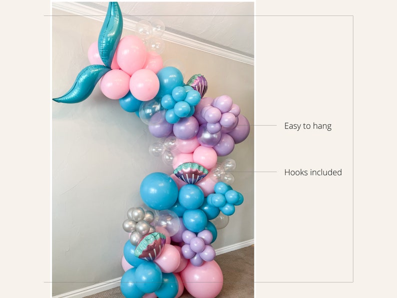 K&ouml;nnte beinhalten: Eine Meerjungfrauen-Ballon-Girlande mit rosa, blauen, violetten und silbernen Ballons. Die Girlande ist mit Muscheln und einem Meerjungfrauen-Schwanz verziert. Einfach aufzuh&auml;ngen mit im Lieferumfang enthaltenen Haken.