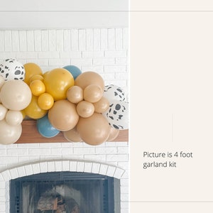 May include: A 4-foot balloon garland kit featuring a mix of colors. The balloons are in shades of beige, yellow, blue, and brown, with some patterned with black spots. The garland is displayed above a fireplace.