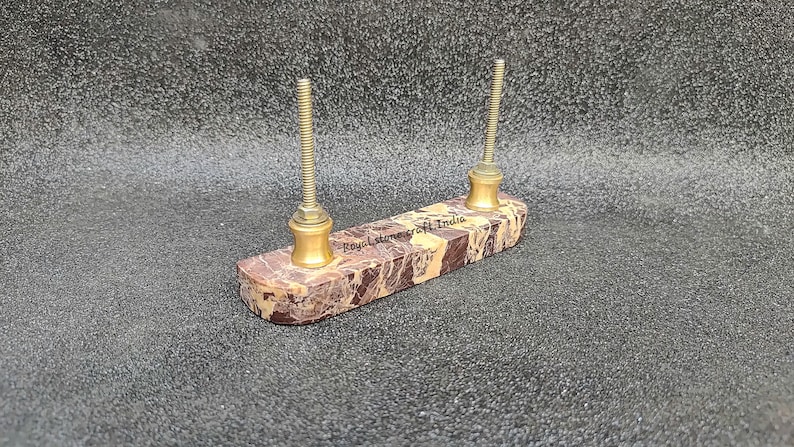 Back view of straight marble door handle with dual brass screw fittings, natural brown marble showing installation hardware and solid stone construction