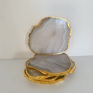 Gold edge agate stone coasters, Agate coasters in the uk, crystal coasters with gold edge, Gold and white agate stone coasters. Housewarming