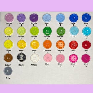 May include: A collection of colorful round buttons in various shades, including purple, blue, green, yellow, gold, orange, red, pink, brown, black, white, and gray. Each button has four holes and a number label.