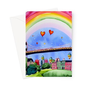 May include: A watercolor painting of a city skyline with a rainbow arching over it. There are hot air balloons in the shape of hearts and stars in the sky. The city has a bridge and buildings with red roofs.