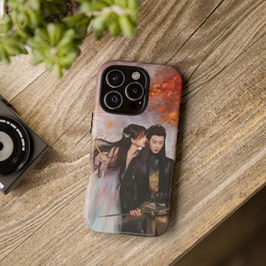 May include: A phone case featuring a romantic illustration of a couple in traditional attire. The artwork depicts a woman whispering to a man, set against a backdrop of autumn colors. The case has a glossy finish and a camera cutout.