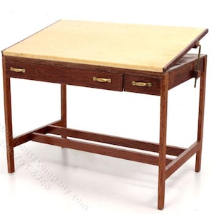 May include: A wooden drafting table with a light brown top and three drawers. The table has a metal clamp to adjust the angle of the top.