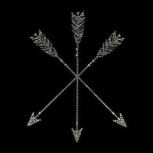 May include: Four silver arrows pointing in different directions, made of rhinestones, on a black background.