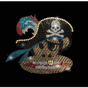 May include: A rhinestone pirate design on a black background. The pirate wears a black hat with a skull and crossbones, a red and blue parrot, and a gold earring. The pirate has a gold tooth and a blue bandana.