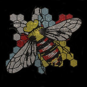 May include: A colourful rhinestone bee design with a yellow head, black and white wings, and a red and yellow striped body. The bee is surrounded by a honeycomb pattern in shades of blue, yellow, and red.