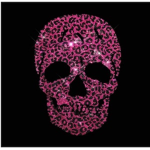 May include: A pink and black skull design made of rhinestones. The skull is outlined in black and the rhinestones are arranged in a leopard print pattern.