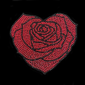 May include: A red rose made of rhinestones in the shape of a heart.