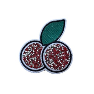 May include: A red and green embroidered cherry patch with rhinestones. The cherry is made of red and silver rhinestones and has a green leaf.