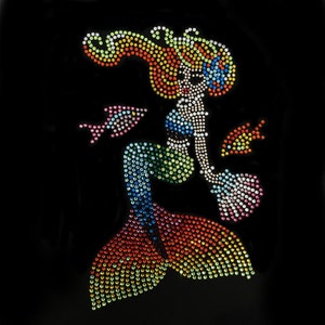 Peut inclure: Un motif de sirène coloré fait de strass. La sirène a une longue queue flottante et est entourée de petits poissons. Le motif est parfait pour ajouter une touche de fantaisie à tout projet.