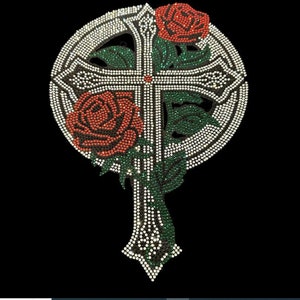 May include: A white, green, and red rhinestone cross with two red roses. The cross is surrounded by a circle of rhinestones.