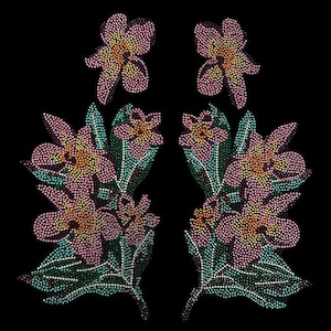 May include: A pair of floral appliques with pink and green rhinestones. The appliques are made of small, round rhinestones that are arranged in a floral pattern. The appliques are perfect for adding a touch of sparkle to any project.