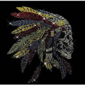 May include: A colorful rhinestone skull design with a Native American headdress. The skull is outlined in clear rhinestones and the headdress is made of red, yellow, blue, and green rhinestones.